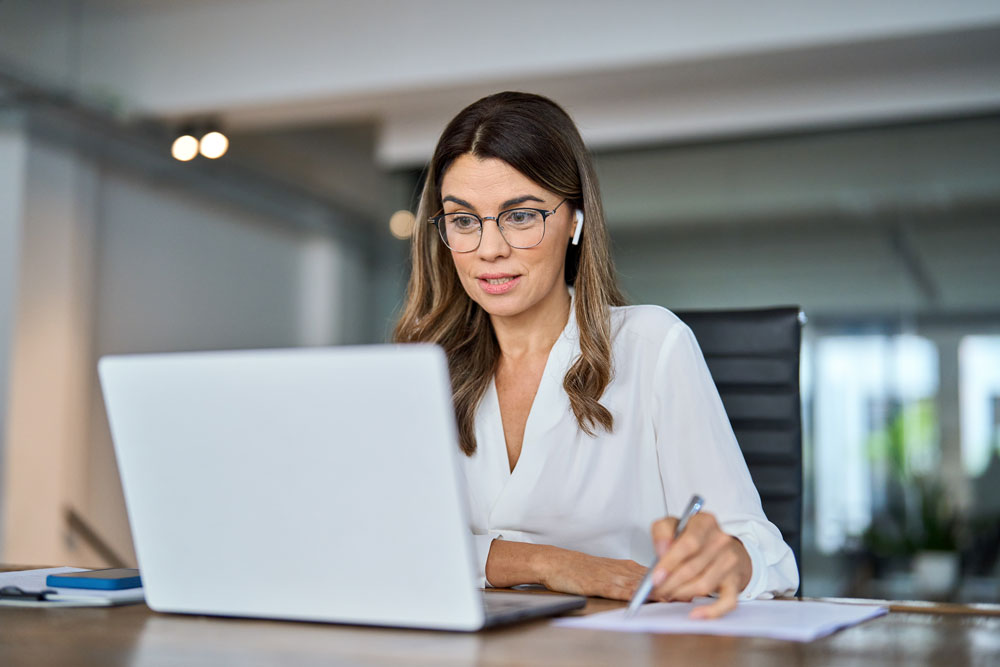Woman using laptop with local IT company support